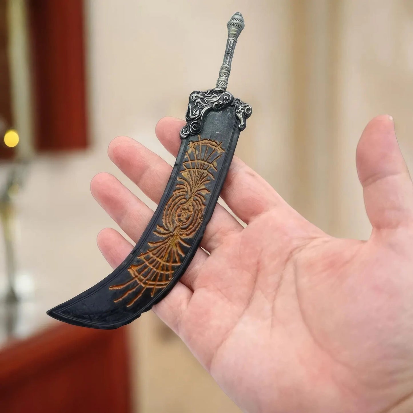 Greatsword of Radahn keychain shown in hand for scale