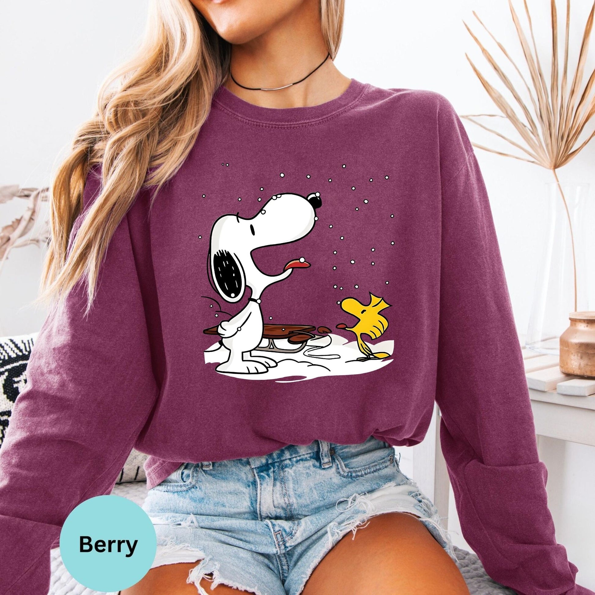 Berry long sleeve woman wearing Snoopy and Woodstock sitting graphic
