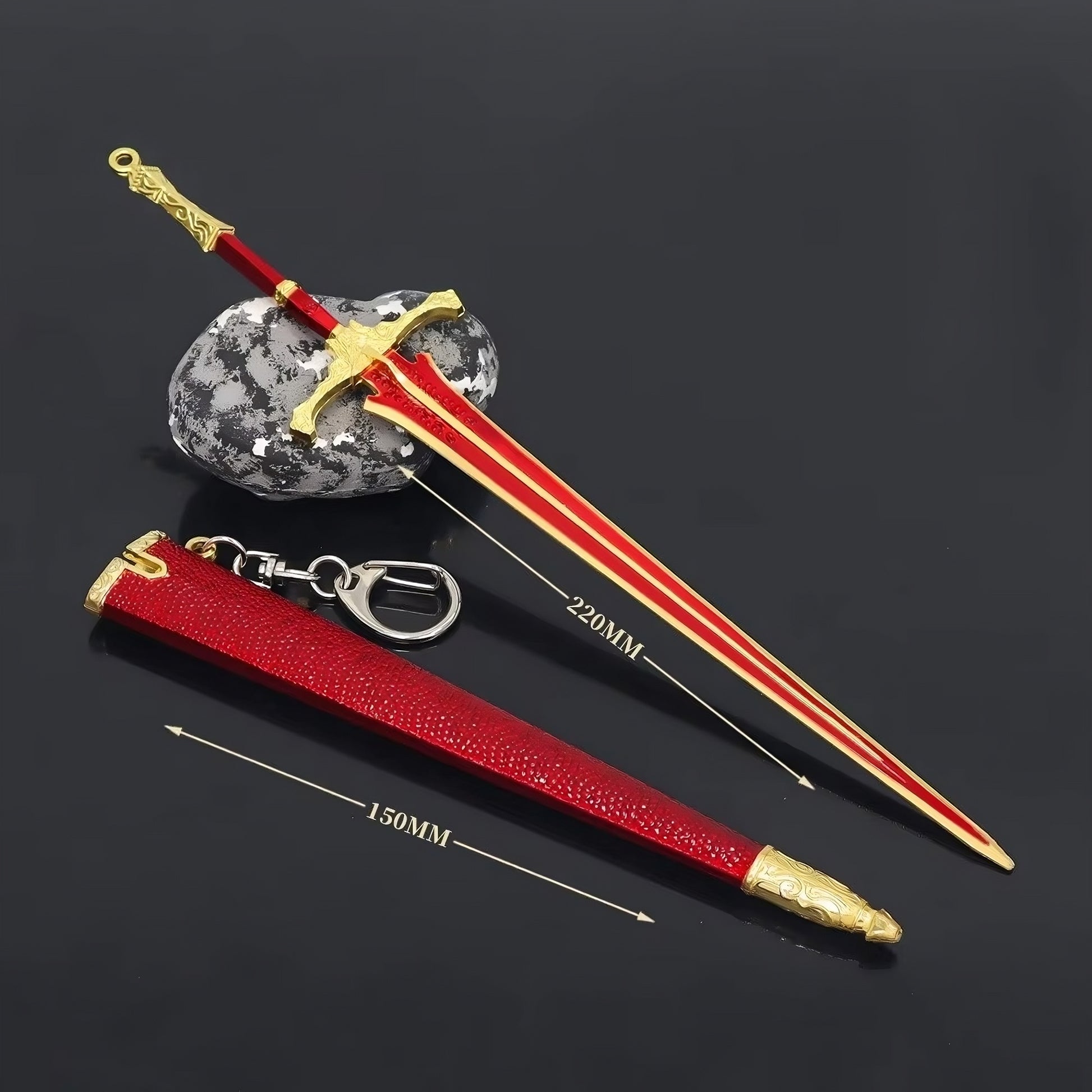 Mini fantasy greatsword replica angled view with red scabbard and metal details