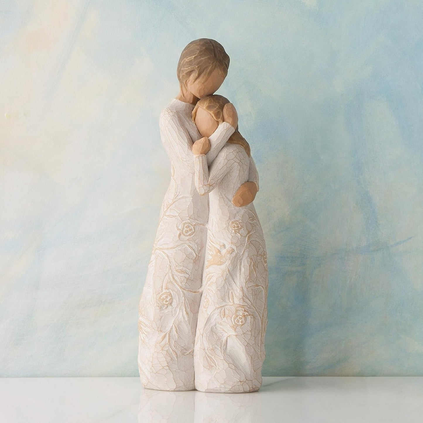 Decorative figurine of two people embracing on a soft gradient background