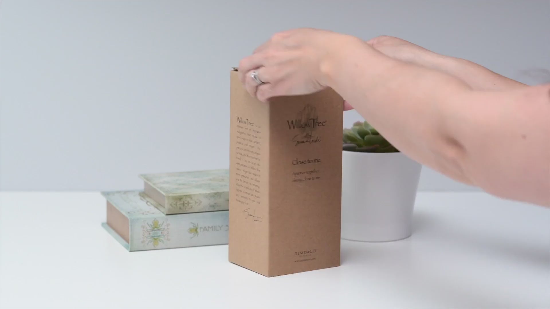 Unboxing hand-painted close to me figurine showing gift box packaging