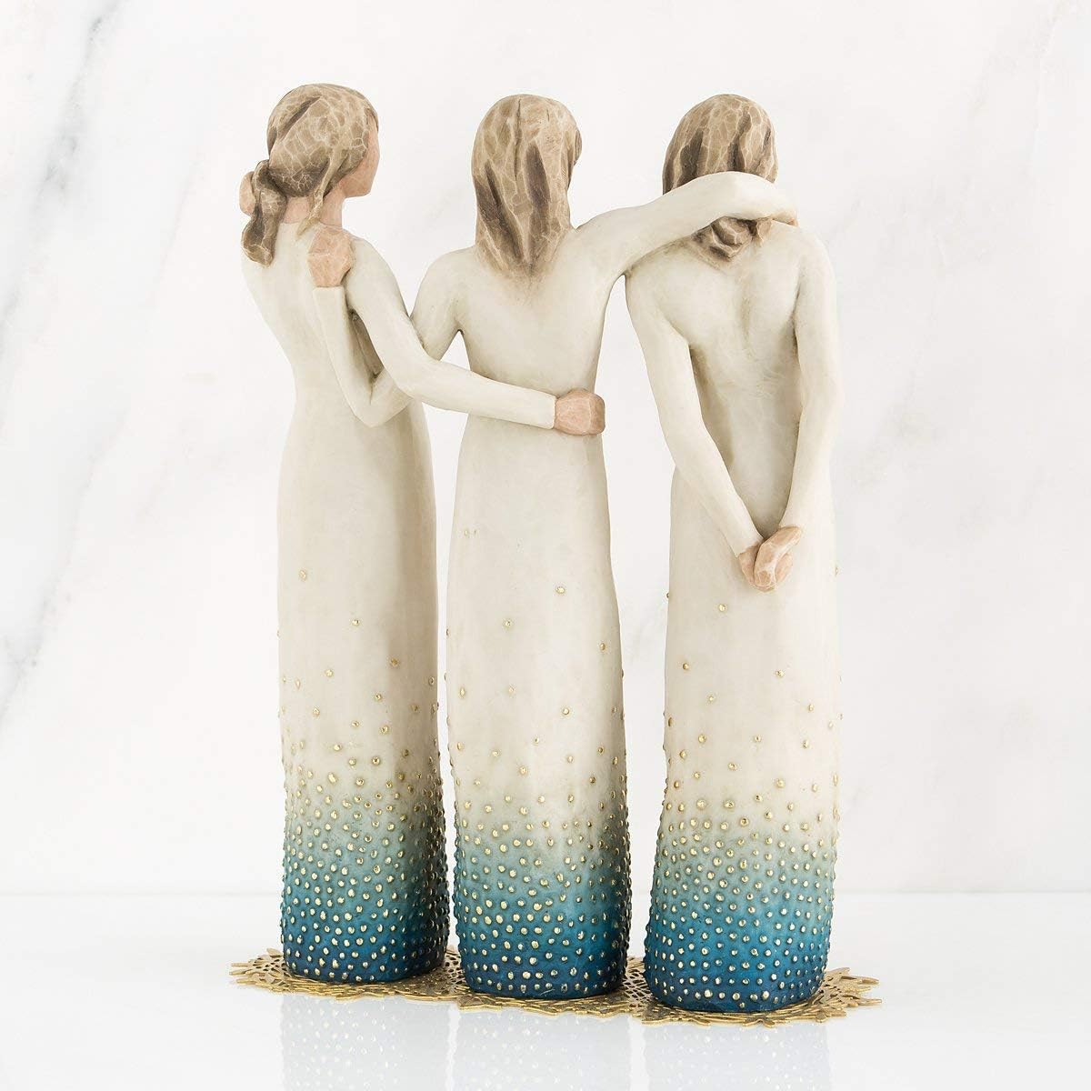 Three figures with ombre dresses and textured bodies on a white background