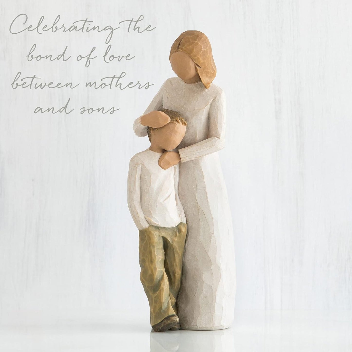 Statue of a mother and son embracing with text 'Celebrating the bond of love between mothers and sons' on a white background