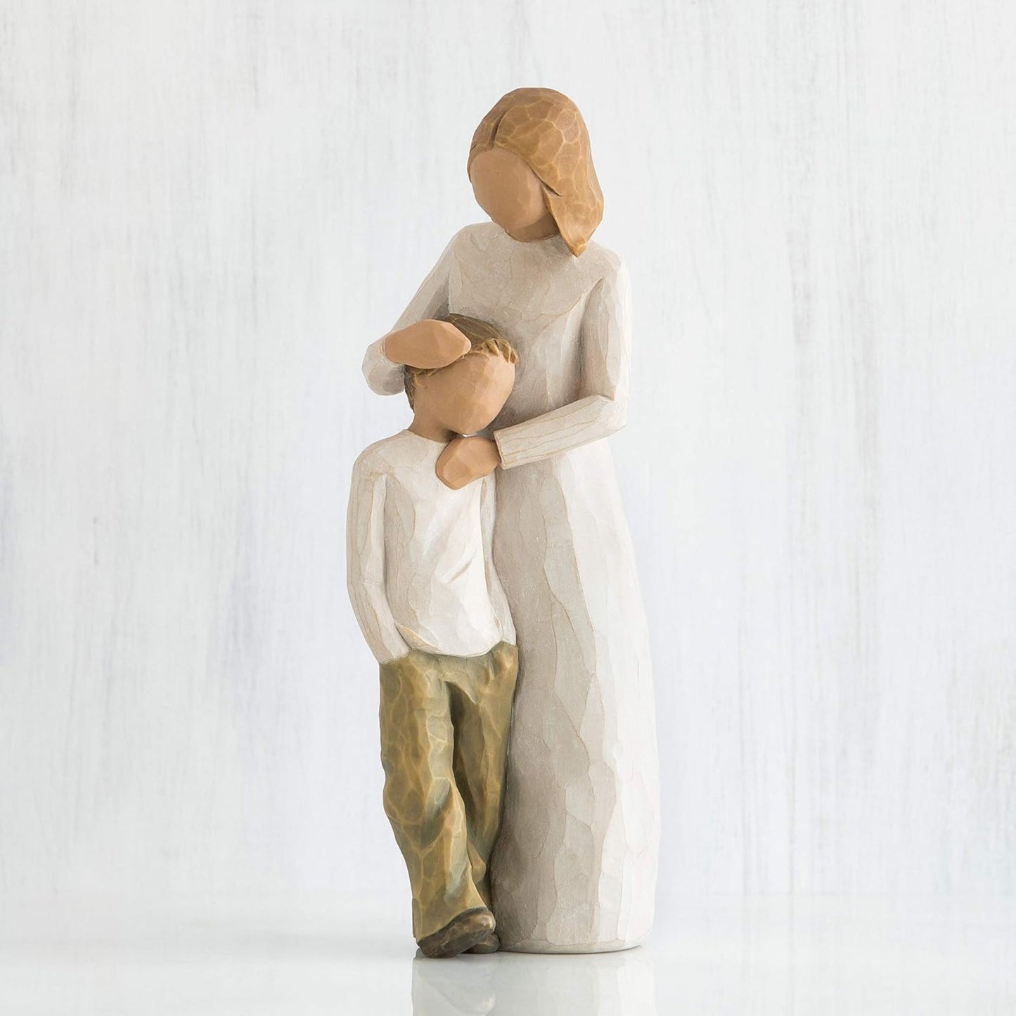 Statue of a mother embracing her son on a white background