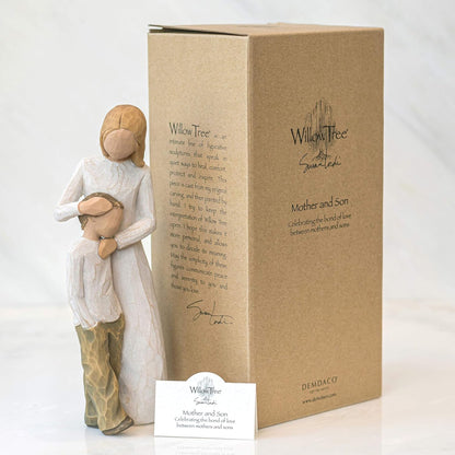 Willow Tree figurine of a mother holding a child next to its packaging box on a white background