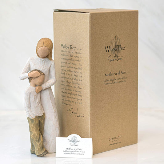 Willow Tree figurine of a mother holding a child next to its packaging box on a white background