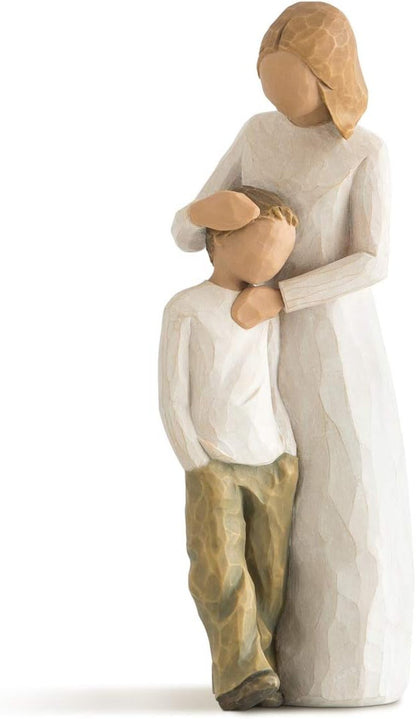 Wooden figurine of a parent holding a child on a white background