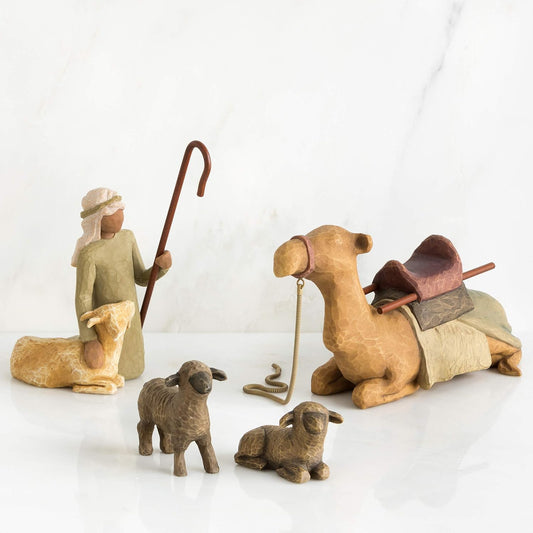 Willow Tree nativity figures featuring a shepherd, camel, and sheep, hand-painted resin figurines on a white background
