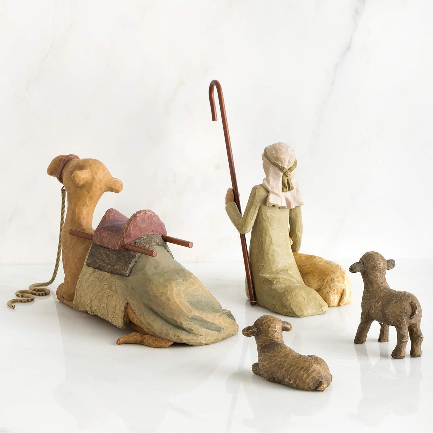Willow Tree Shepherd and Stable Animals nativity figures featuring a shepherd, camel, and sheep, hand-painted resin figurines on a white background
