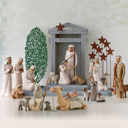 Willow Tree nativity scene with shepherd, Holy Family, camels, sheep, and stable animals, hand-painted resin figurines arranged around a classic manger
