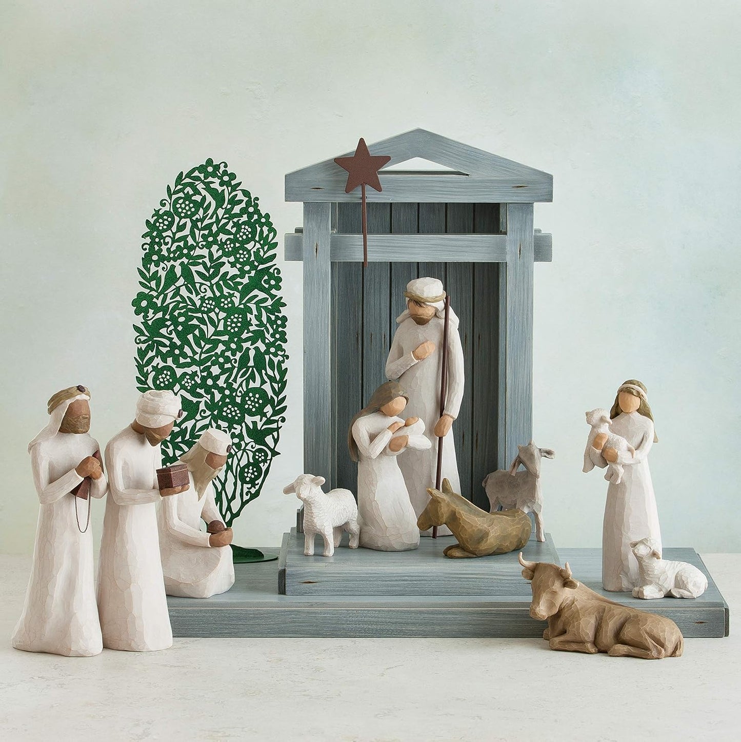 Nativity scene with figures and animals on a white background
