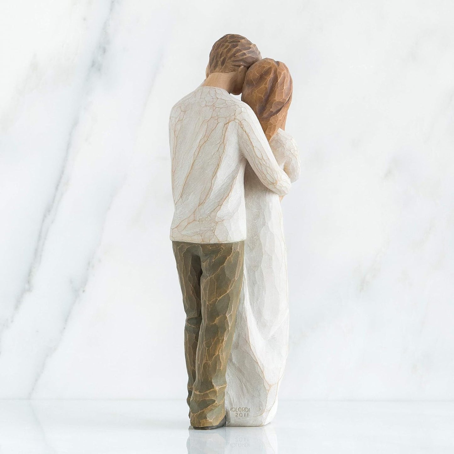 Statue of a couple embracing on a white background