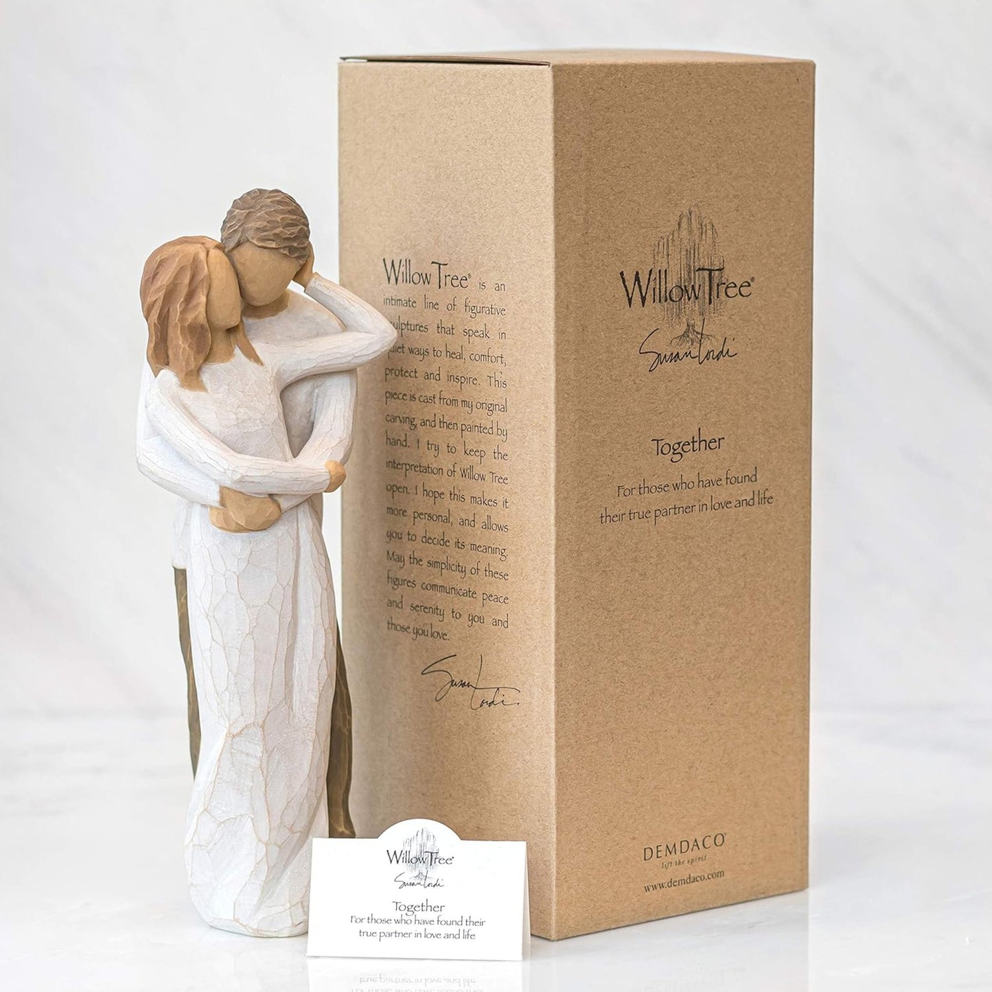 Willow Tree figurine of two people embracing with packaging and card on a white background